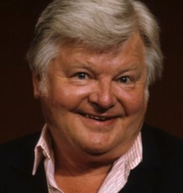 From the Greek: Benny Hill (1924-92) is holding a torn pair of trousers and asks someone, “Euripides?”