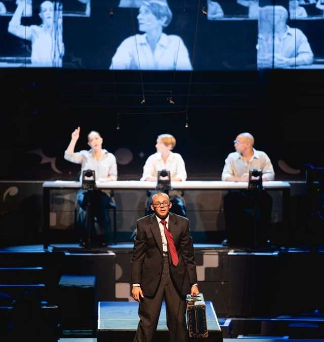 BBC Proms 2025 – Souvenir photo of Shostakovich Symphony Five – Aurora Orchestra/Nicholas Collon: a staged background to the music and a complete performance.